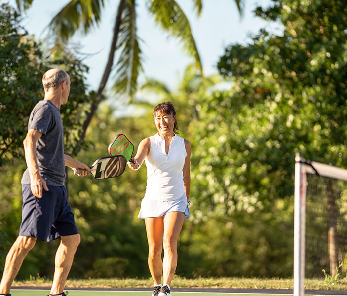 couple playing pickleball at the future Lumena Pickleball Courts