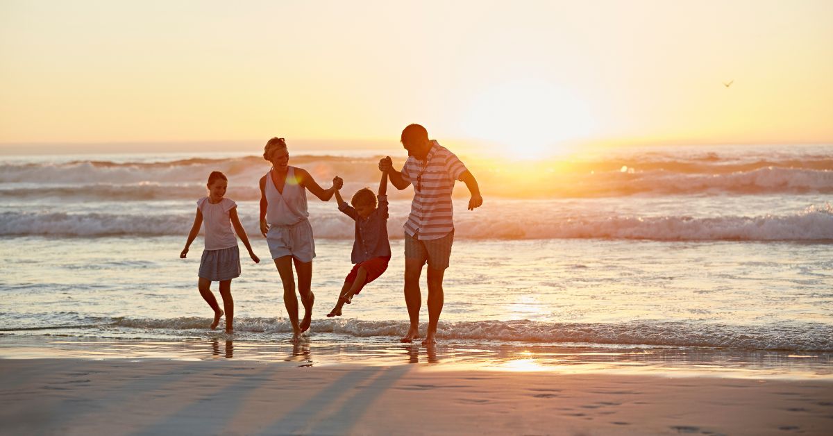 family enjoying sunset on the beach on Florida's Space Coast