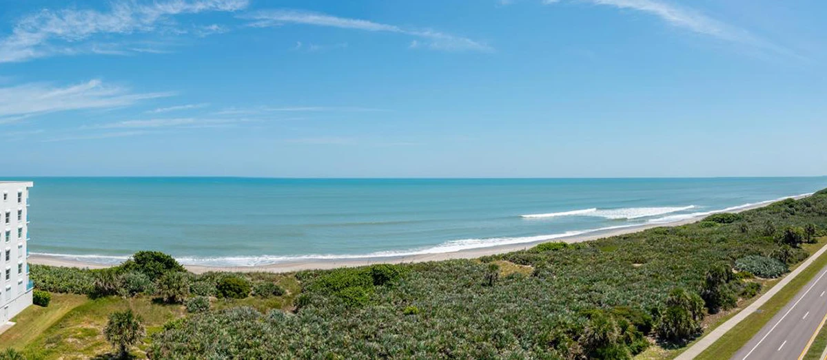 Oceanfront view of Satellite Beach Florida with dunes and coastline