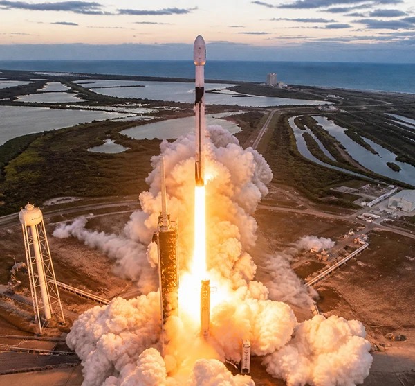 Rocket launches from Florida Space Coast with flames and smoke from above